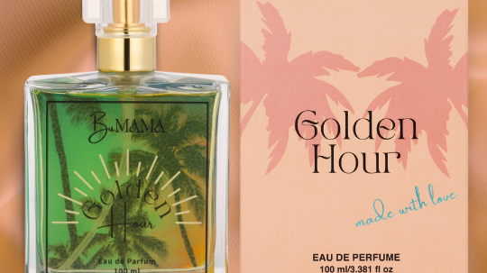 a bottle of Golden Hour Parfum next to the peach colored box it comes in