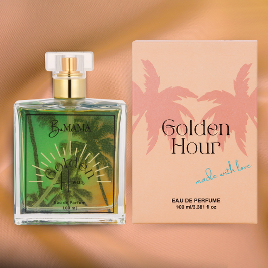 a bottle of Golden Hour Parfum next to the peach colored box it comes in