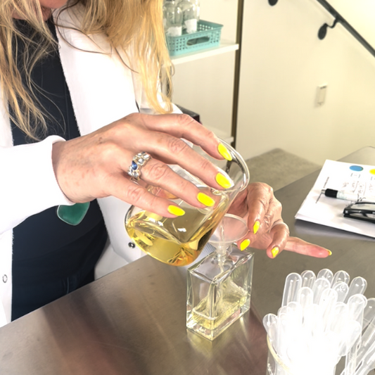 woman pouring perfume