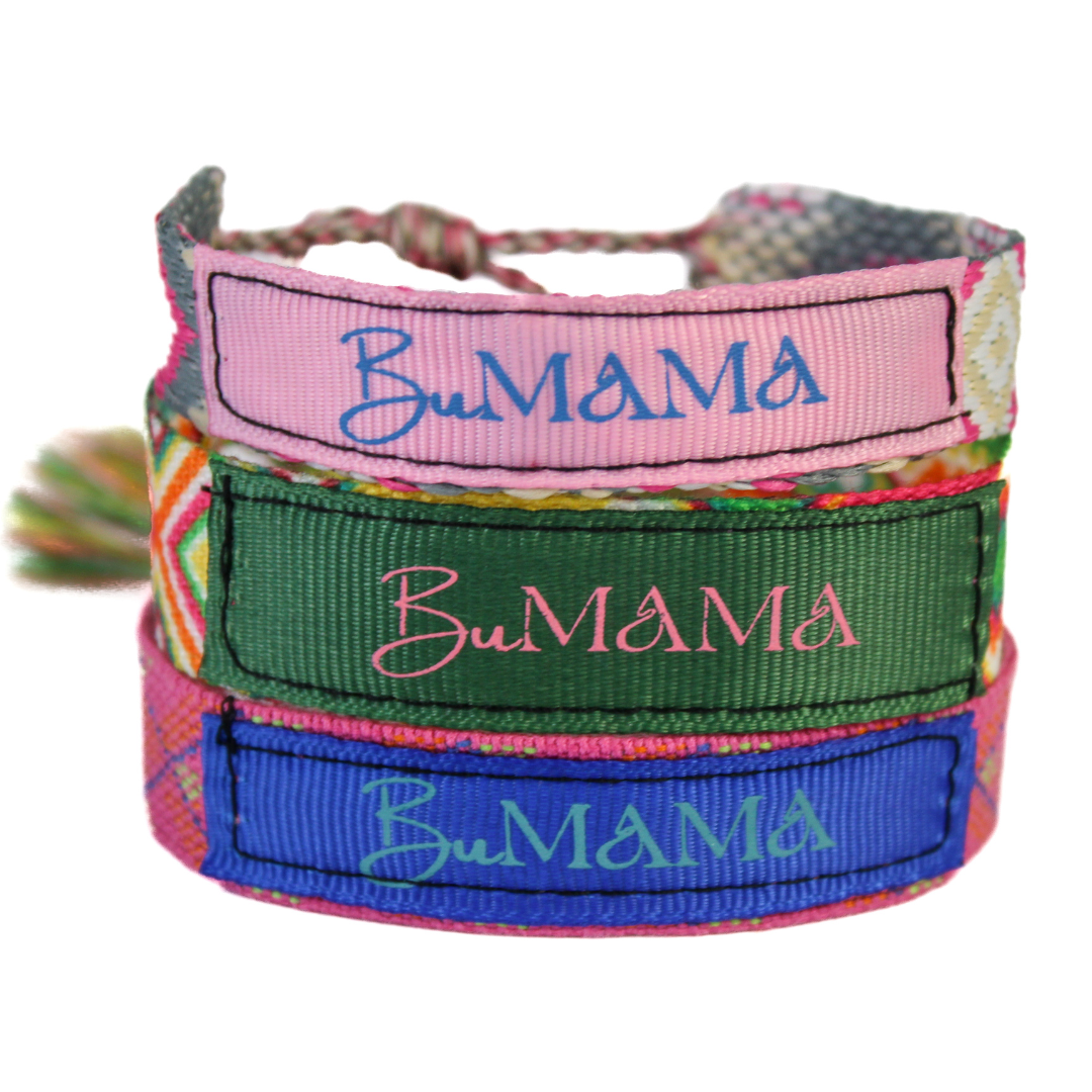 Close-up view of the woven bracelet with green ribbon and BuMama brand name